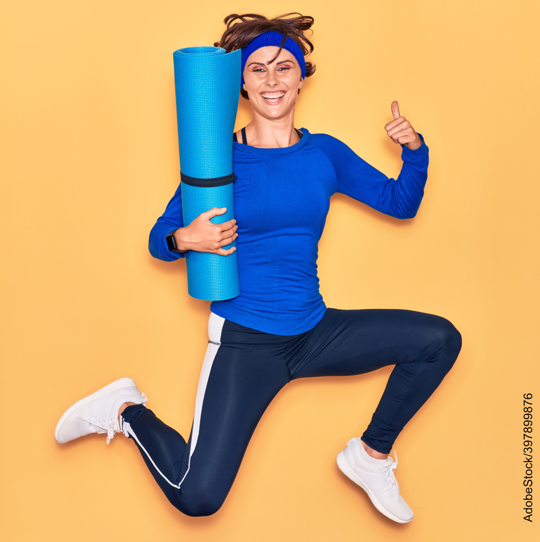 sports woman Jumping with smile on face holding yoga mat